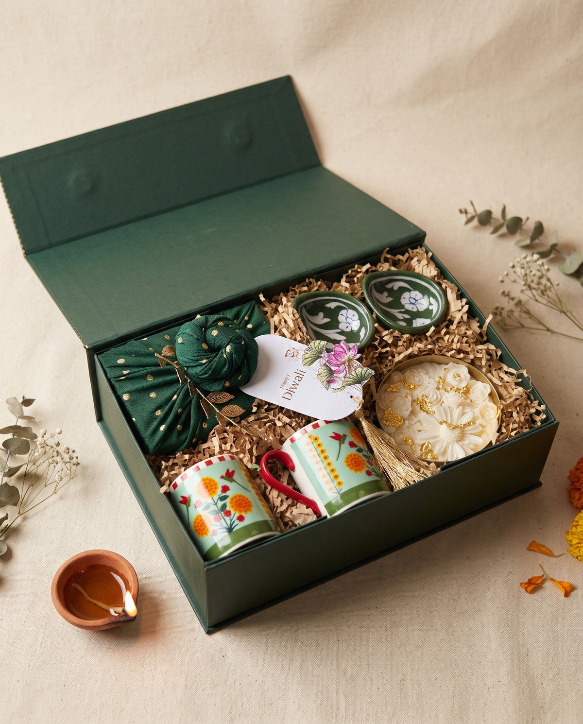 Rani Bagh Diwali Box featuring mugs, diyas, and decorative items for a festive gift.
