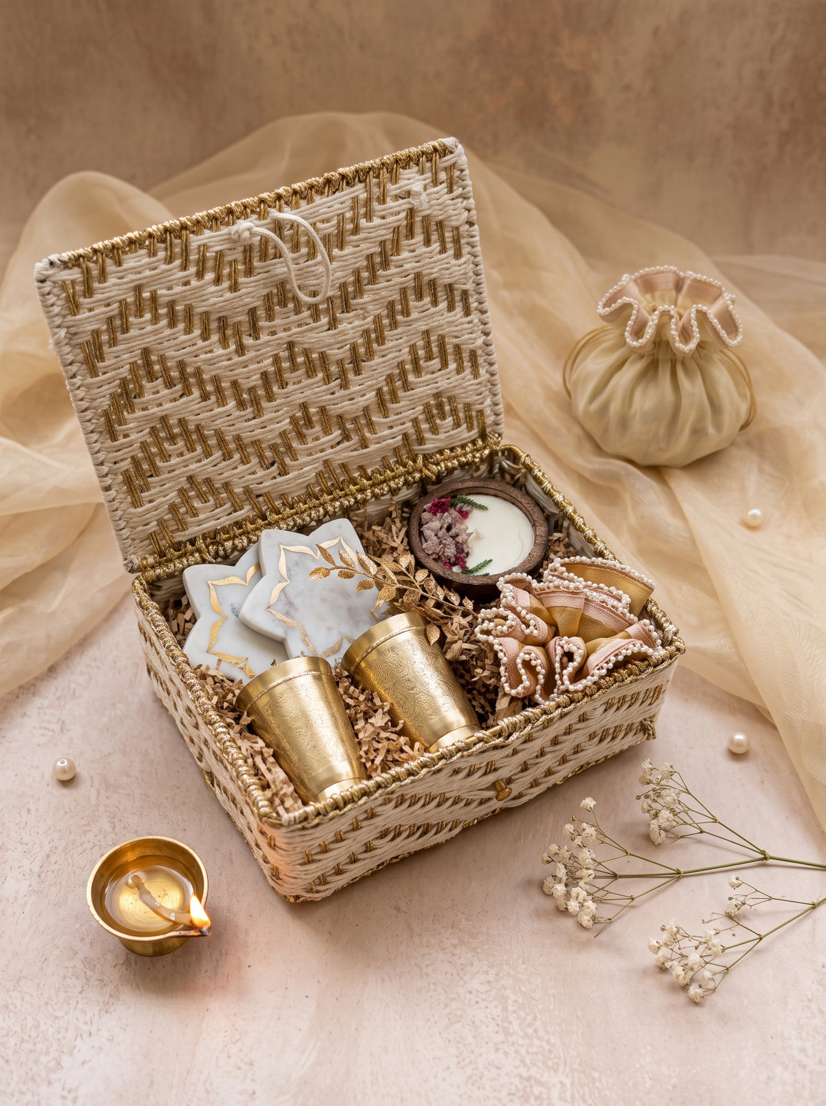 Shubh Labh Keepsake Hamper with brass glasses, marble coasters, and candle in a decorative basket.