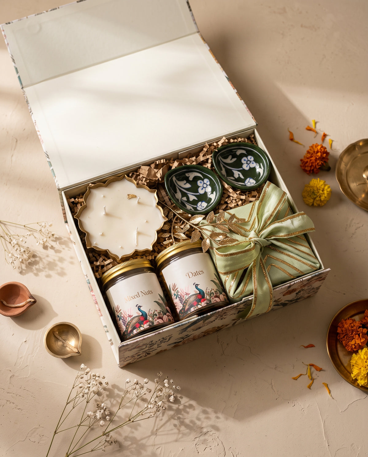 Peacock Garden Festive Box with hand-painted diyas, mixed nuts, dates, and a candle for Diwali celebrations.