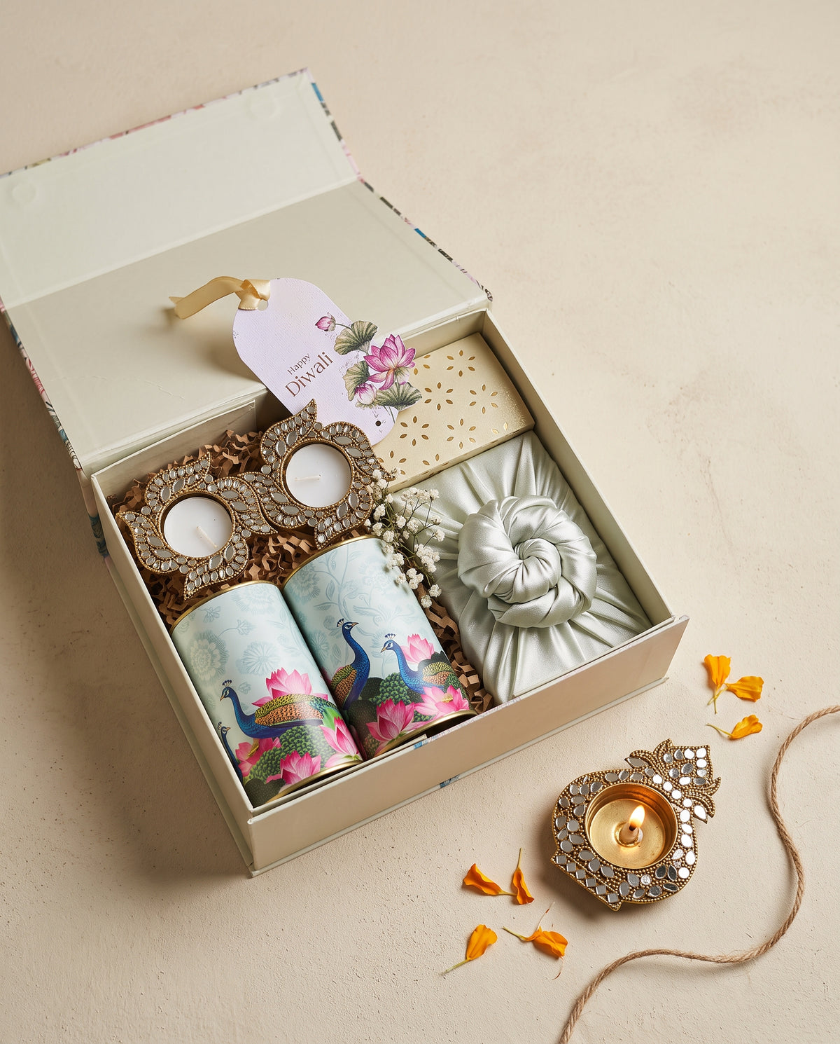 Peacock Lotus Diwali Box featuring kunafa chocolates, Soan papdi, and swastik mirror diyas for Diwali celebrations.