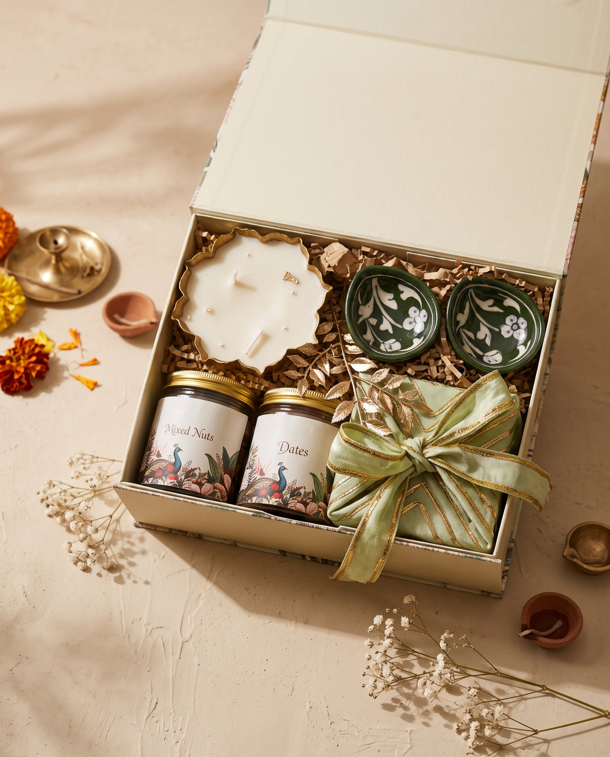 Peacock Garden Festive Box with hand-painted diyas, fresh laddus, and decorative candle.
