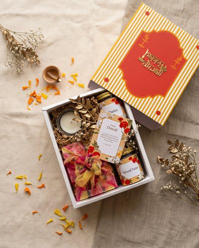 Happy Diwali Box featuring soan papdi, mixed nuts, dates, and a scented candle for the festive season.