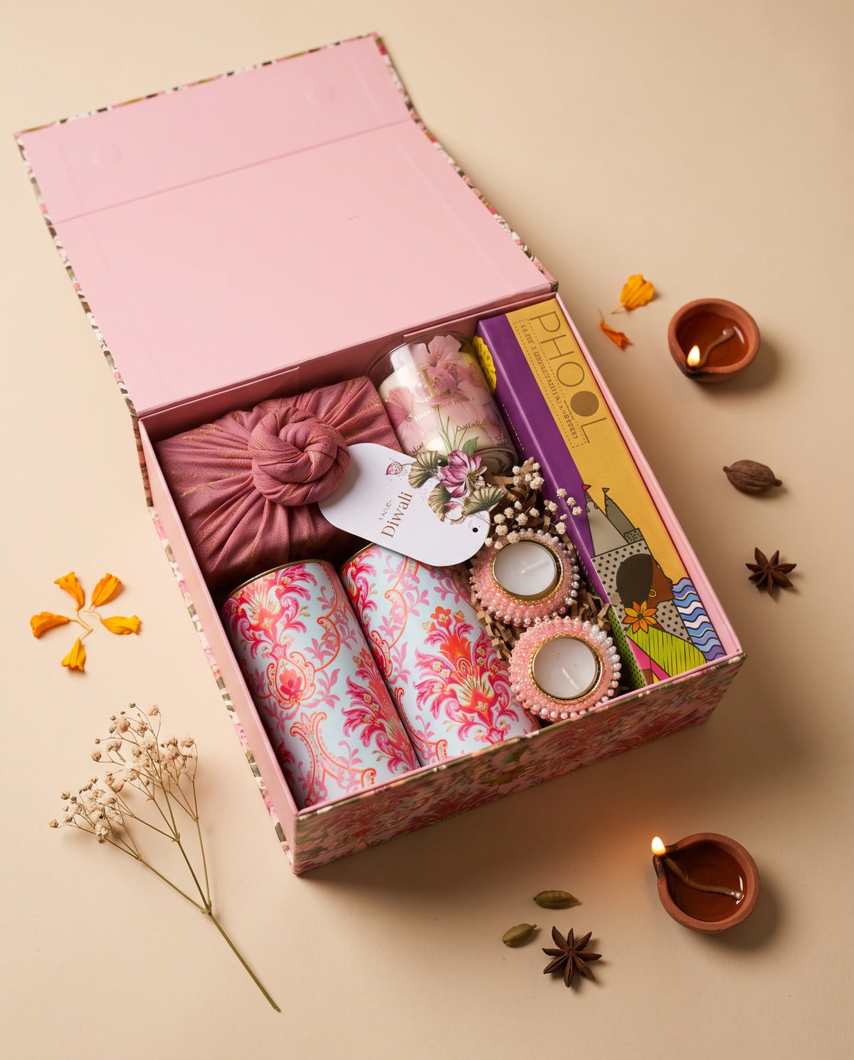 Pink Lotus Hamper in a floral keepsake box with candles, decor, and treats for Diwali celebrations.