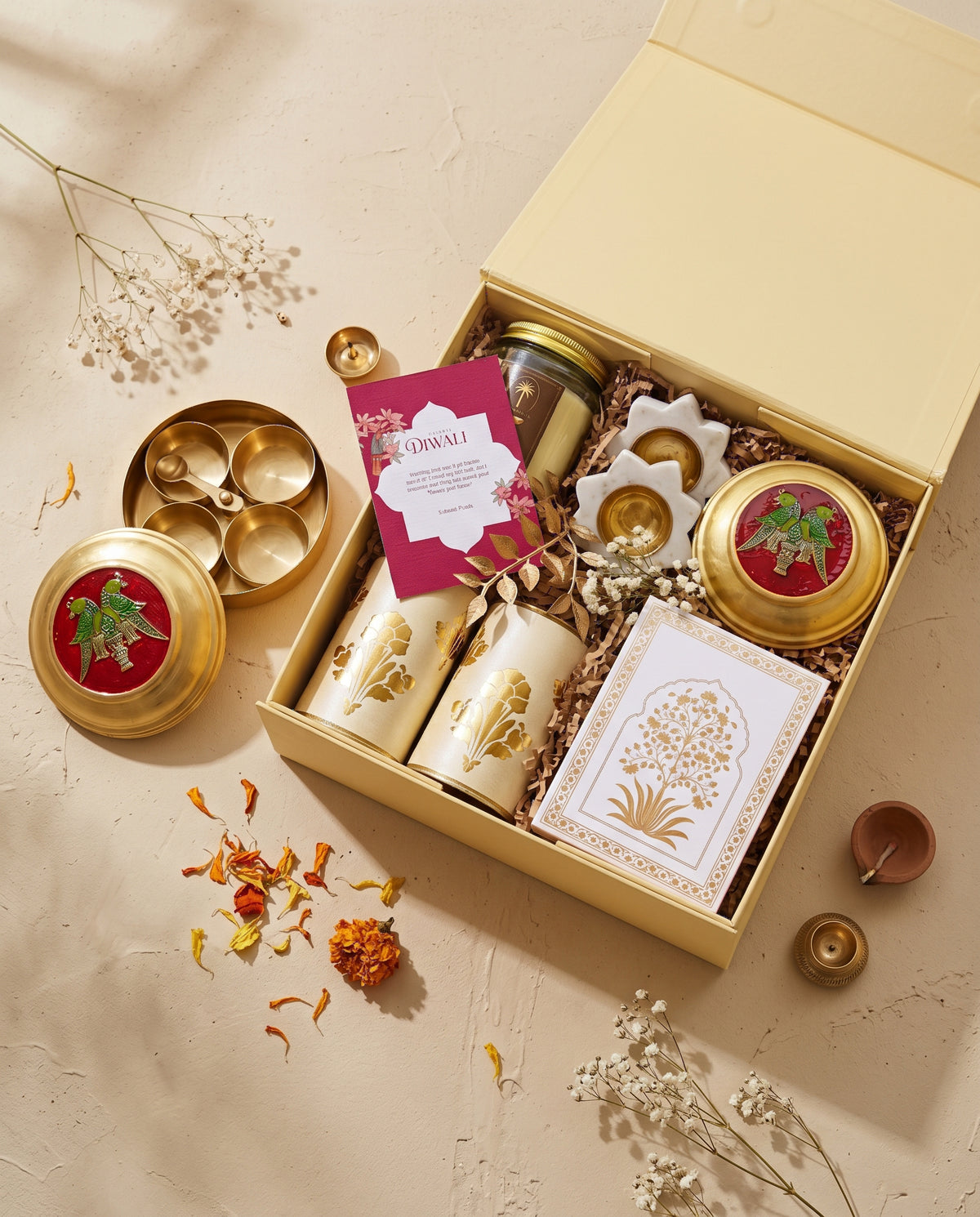 Golden Haveli Box containing brass items, candles, and Diwali gift essentials.