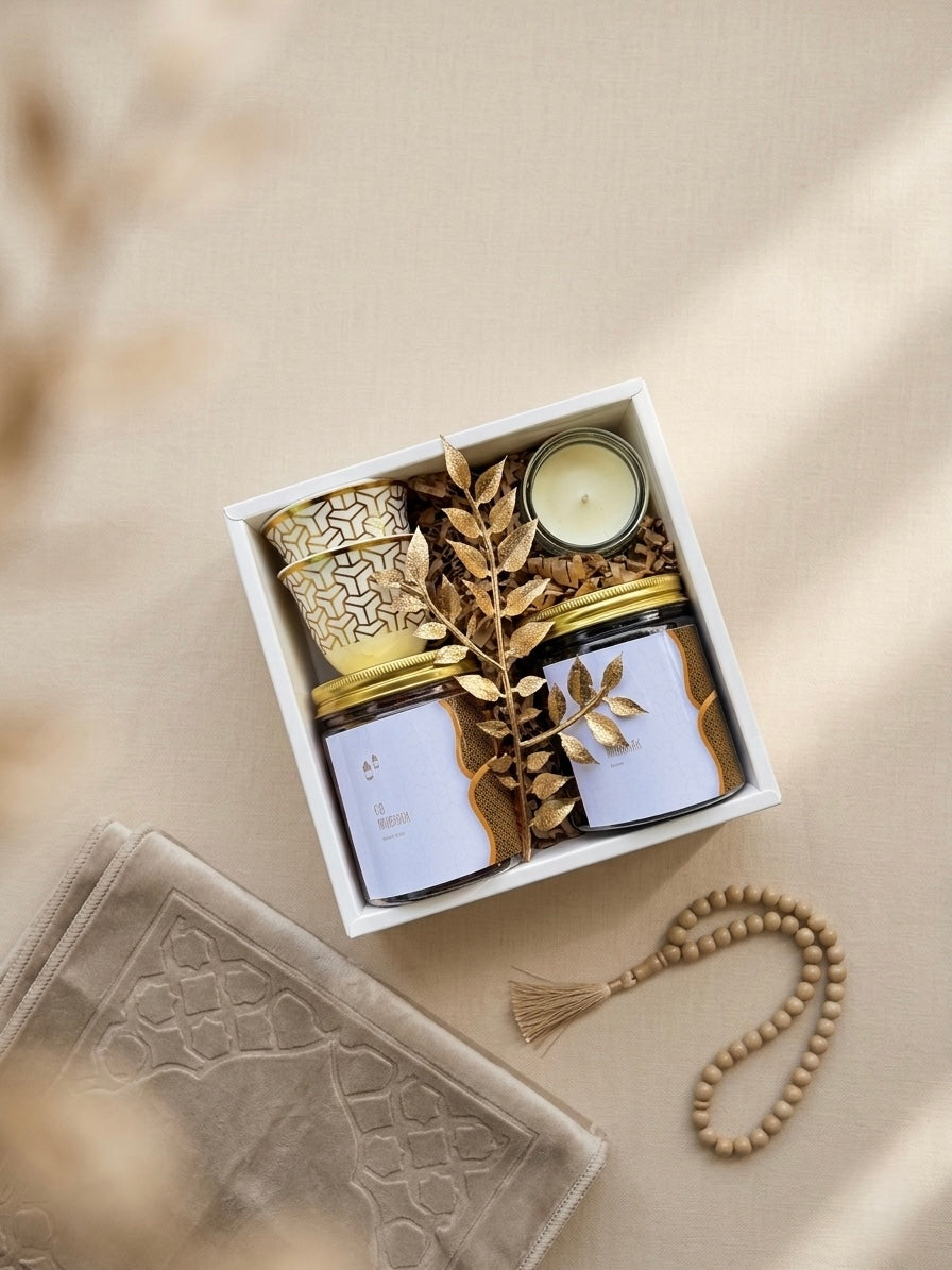 Golden Noor Box featuring gourmet gift box with dates and nuts, including jars of dates, nuts, cups, and a candle.