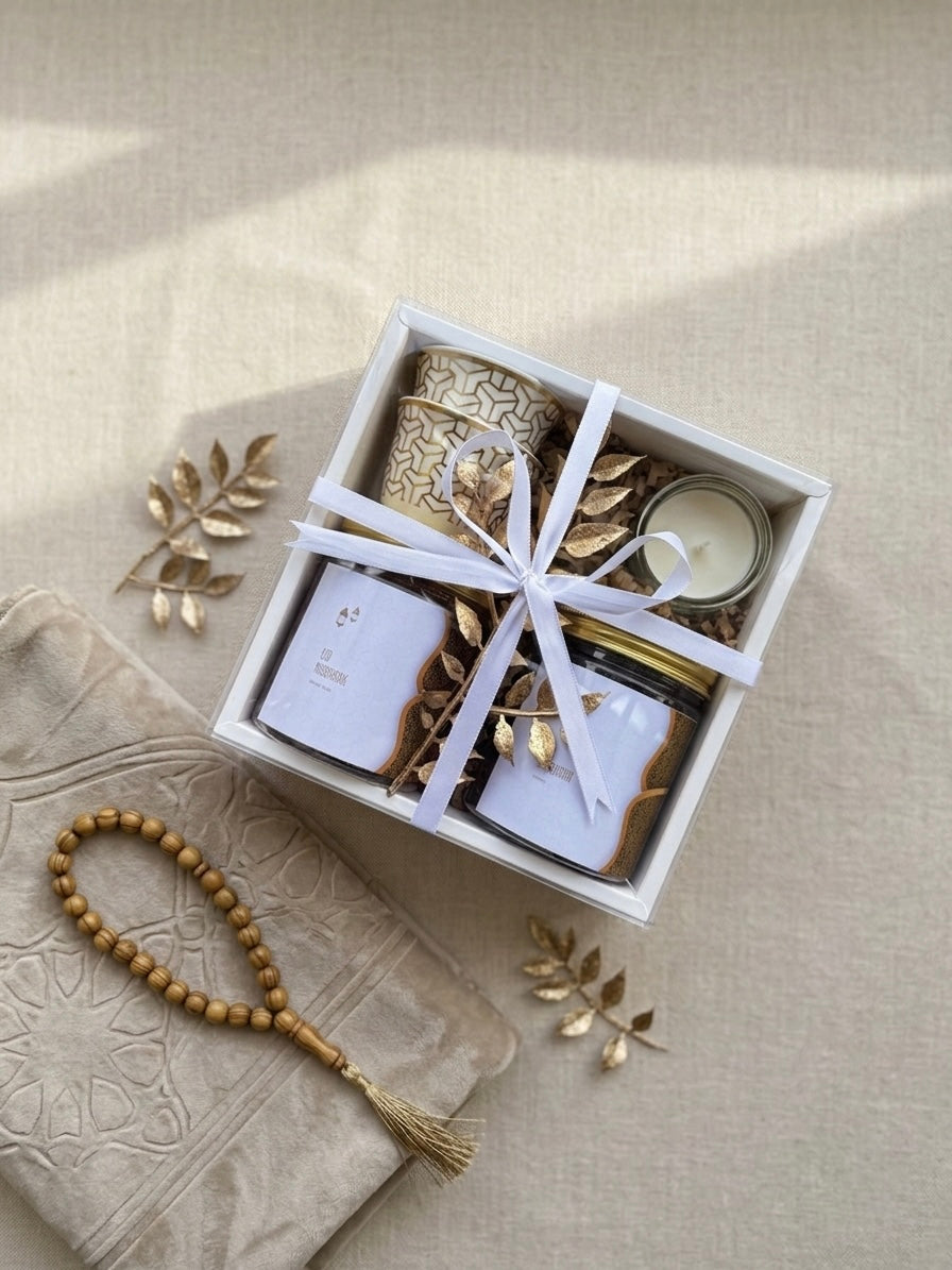 Golden Noor Box containing gourmet gift box with dates and nuts, Kahwa cups, and a mini candle.