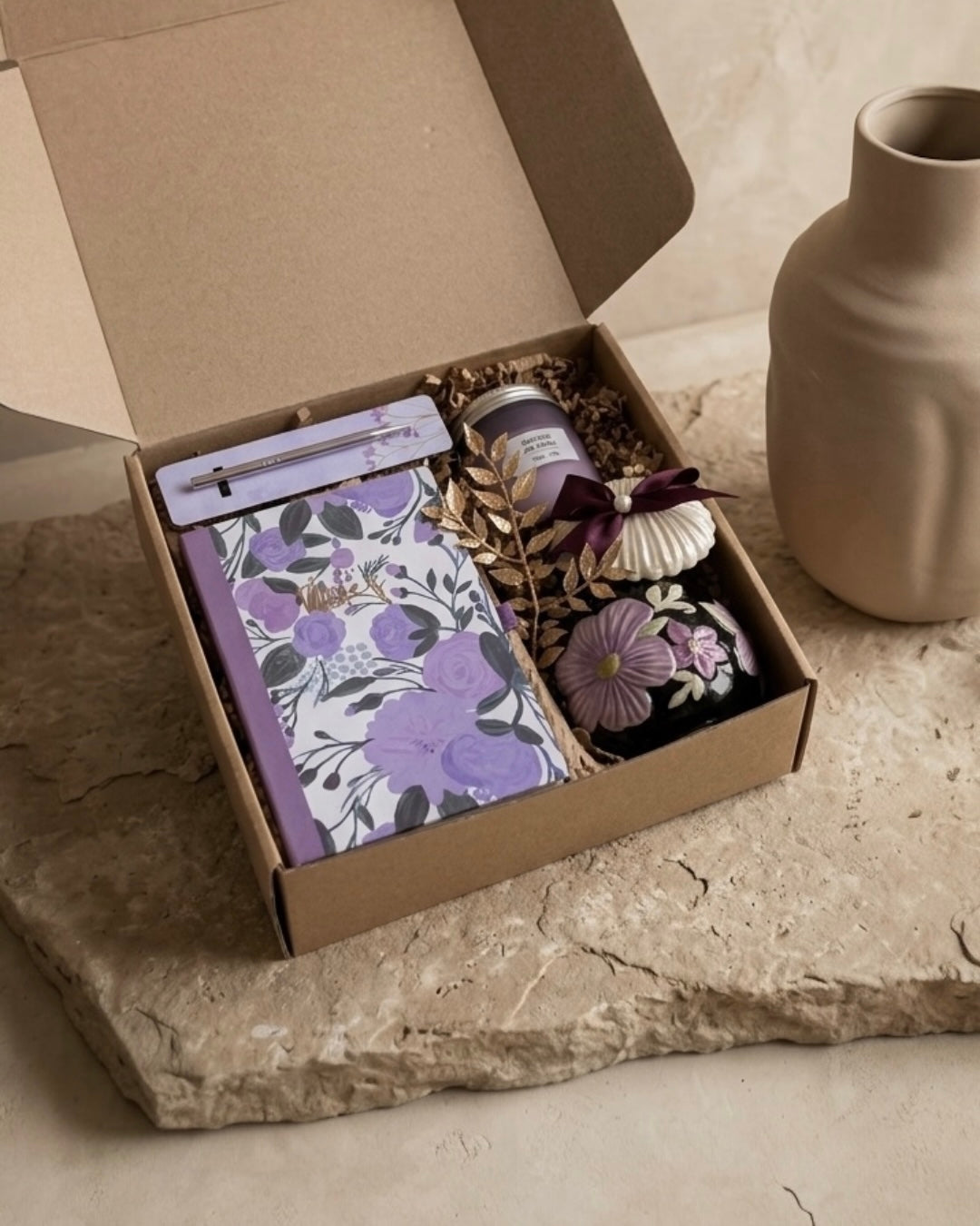Lavender Dreams Box containing floral notebook, botanical mug, luxury candle, and chocolates, an ideal lavender gift box for women.