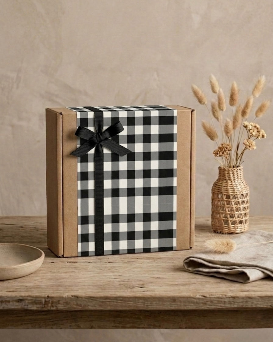 Mr. Awesome gift box for him UAE with black and white checkered design and ribbon on wooden table.