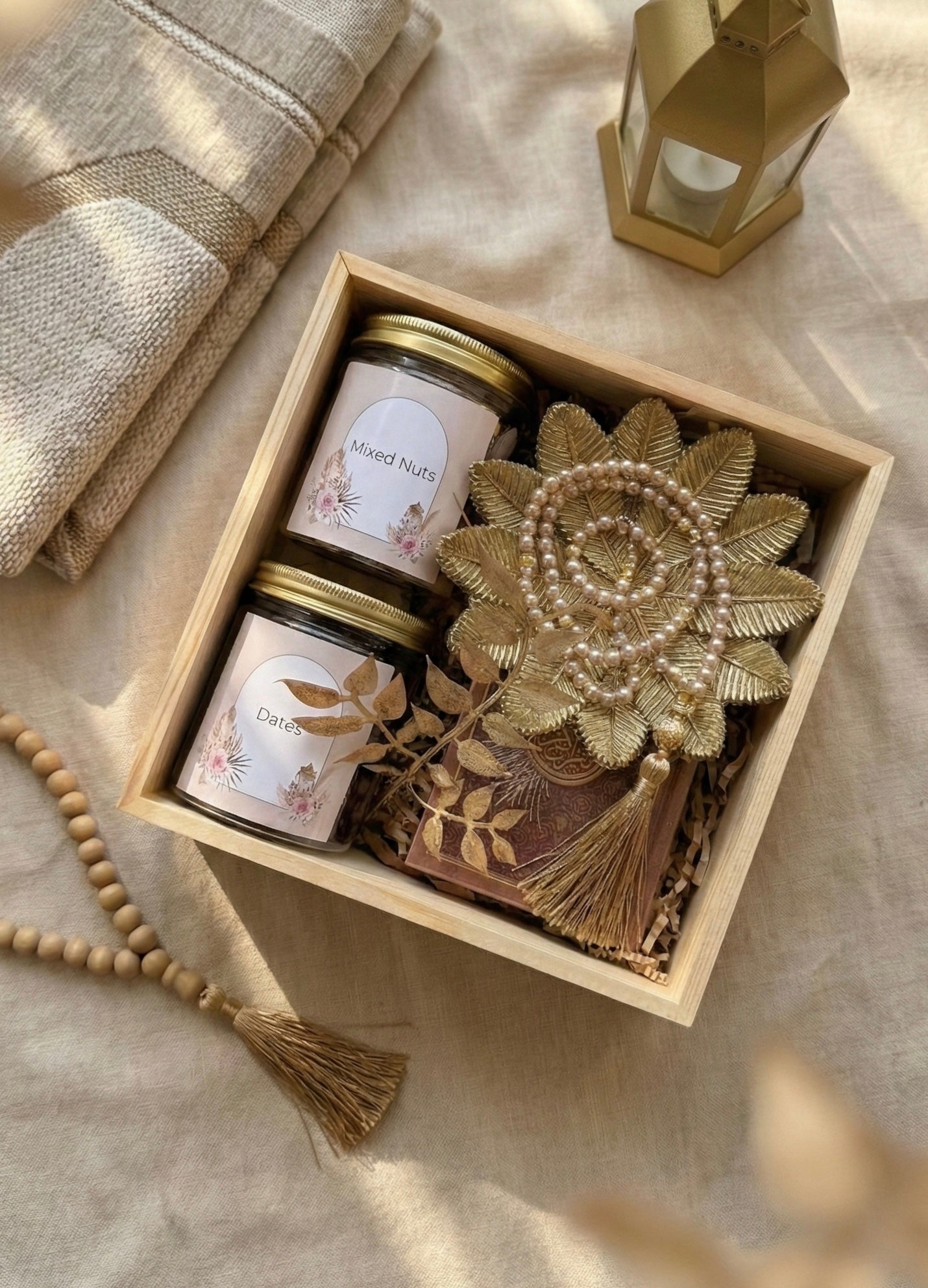 Eid Al Fitr gift boxes containing premium dates, mixed nuts, and decorative items in a wooden box.