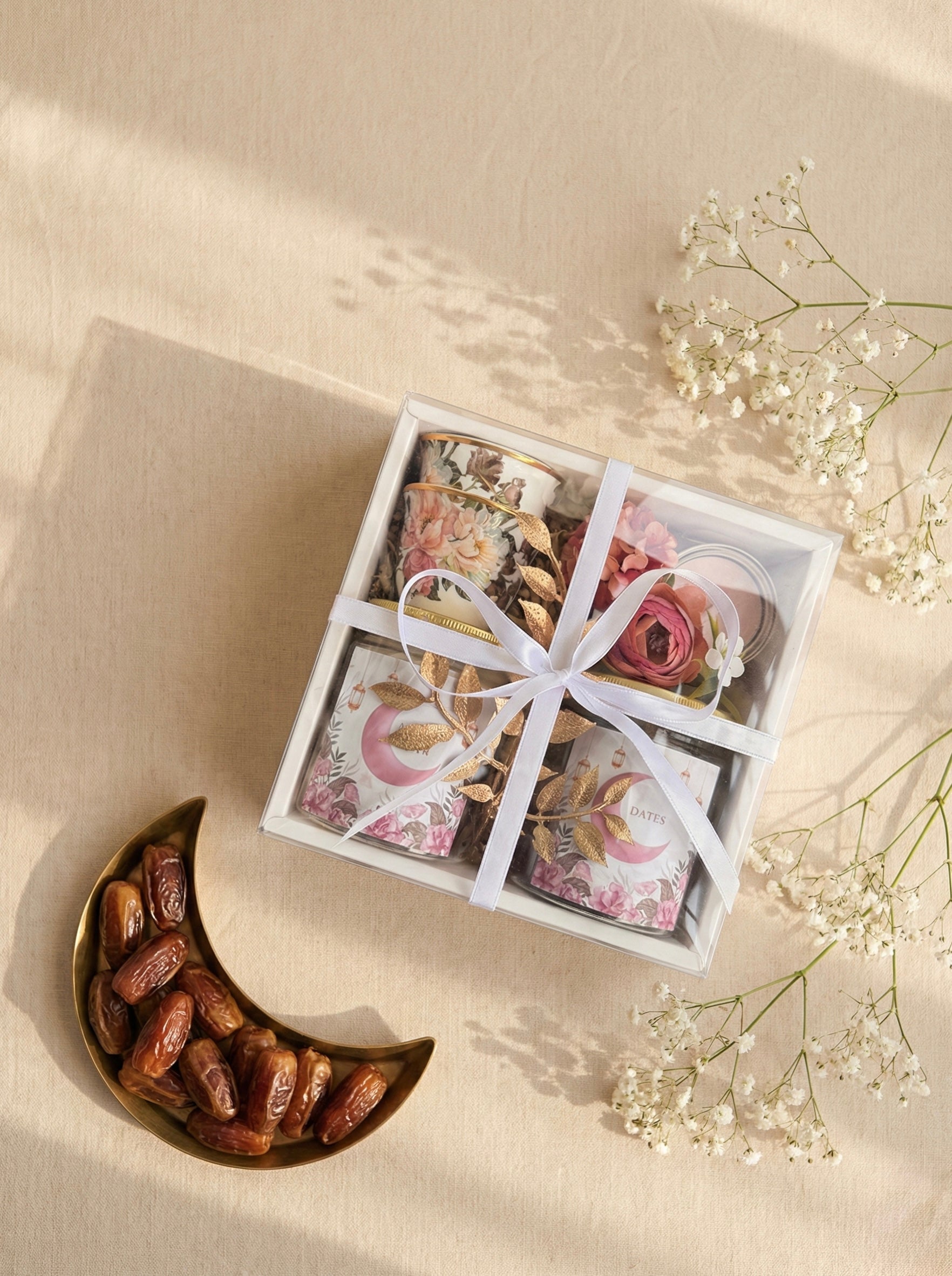 a beautifully arranged Palm Pastel Gift Box featuring dates, mixed nuts, kahwa cups, and a mini candle