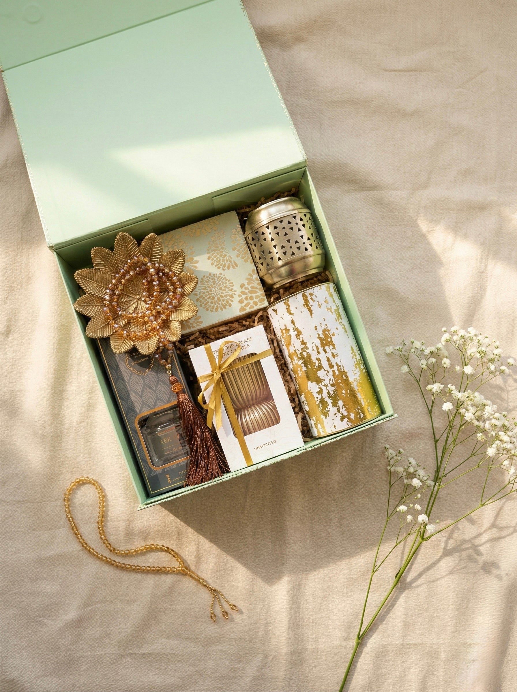 Pistachio Gift Box containing decorative items ideal for Eid gifts, including a lantern, candle, and mixed nuts jar.