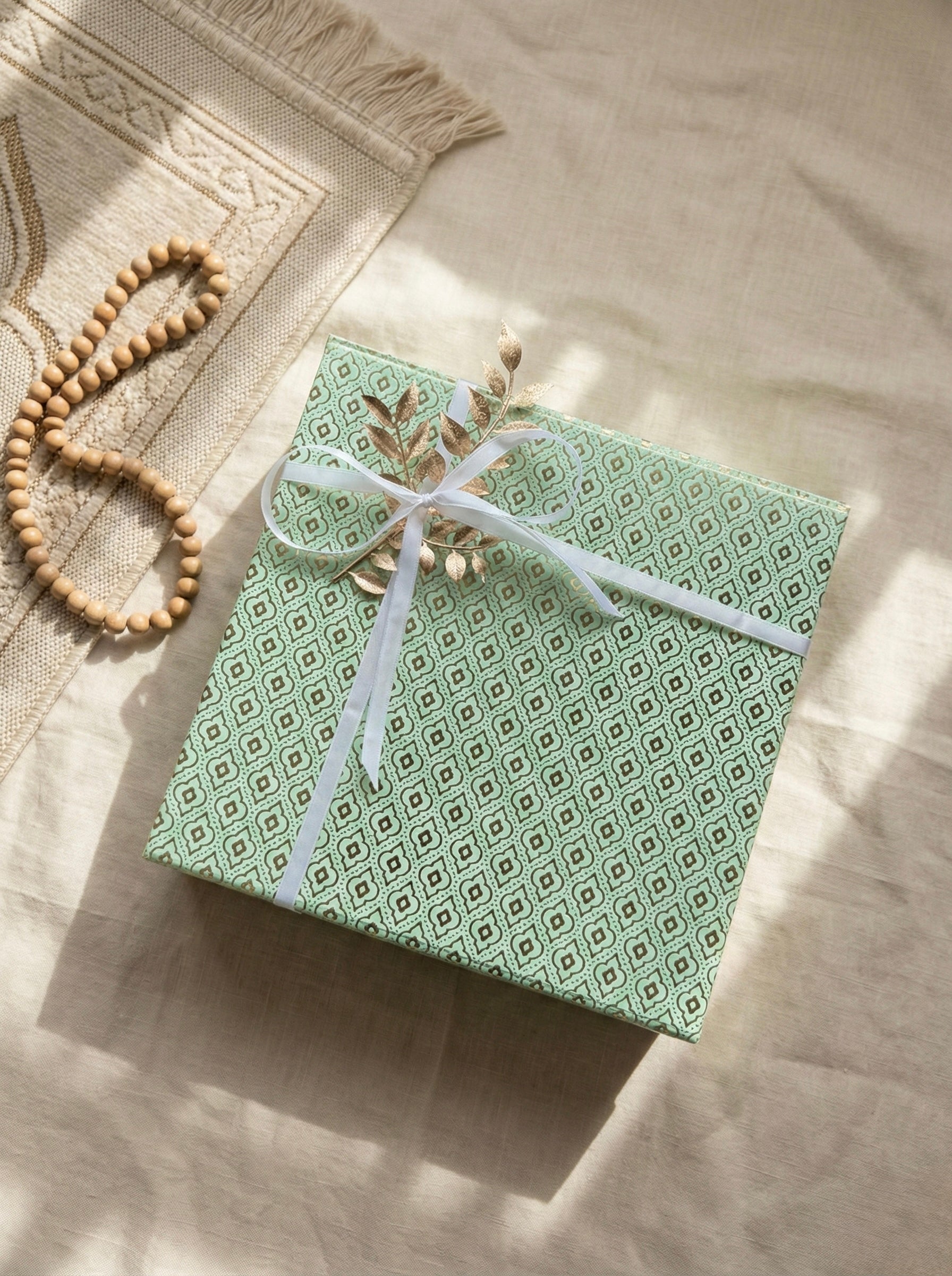 Pistachio Gift Box beautifully wrapped in green patterned paper, perfect for Eid gifts.