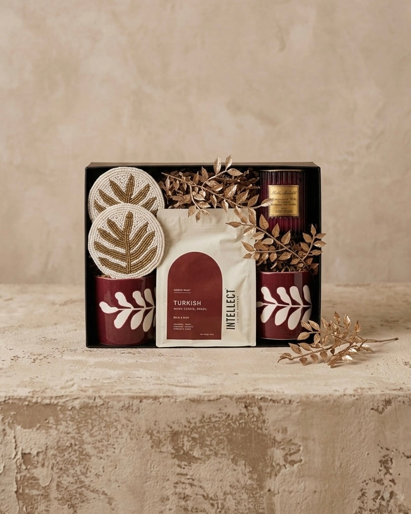 Artisanal coffee gift box featuring Turkish coffee, beaded coasters, floral cups, and luxury scented candle.