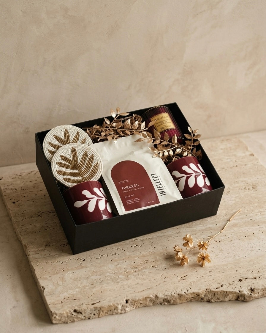 artisanal coffee gift box containing Turkish coffee, beaded coasters, floral cups, and scented candle.
