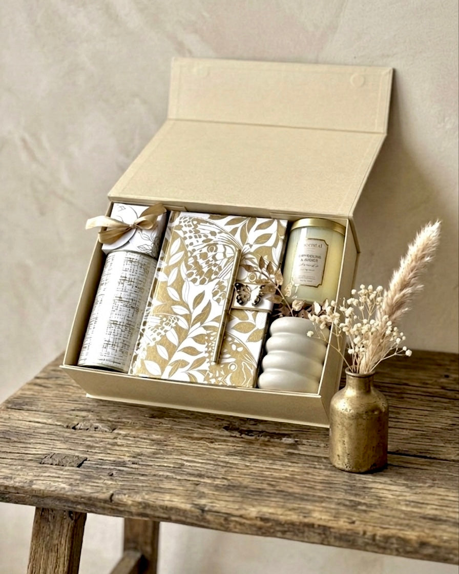 Luxury gift box with silk notebook and assorted elegant items in a beautifully designed package.