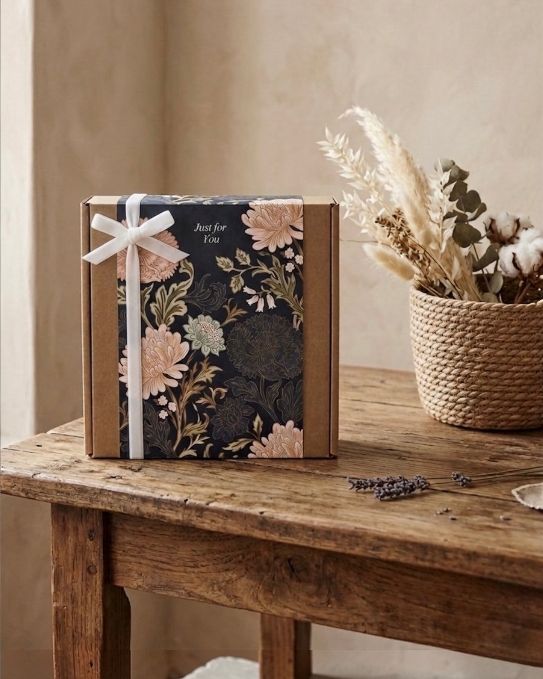 Luxury navy gift box featuring floral design and ribbon, perfect for gifting in a cozy home setting.