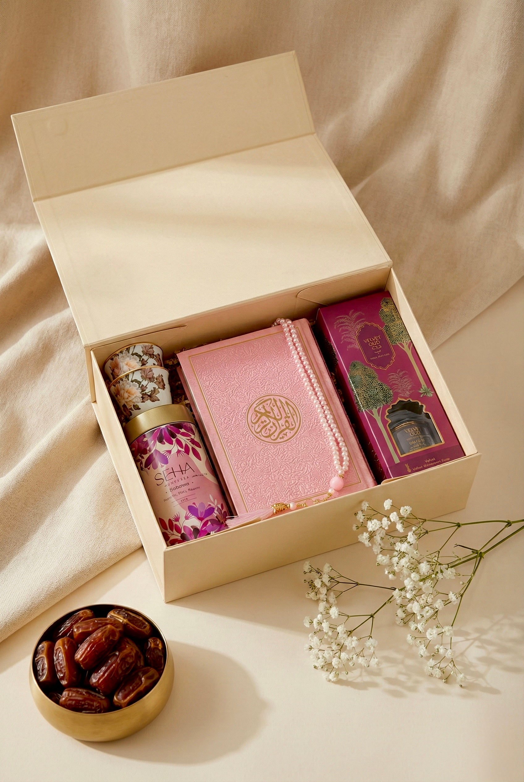 A pastel prayer box filled with a Quran, tasbih, reed diffuser, and kahwa cups.