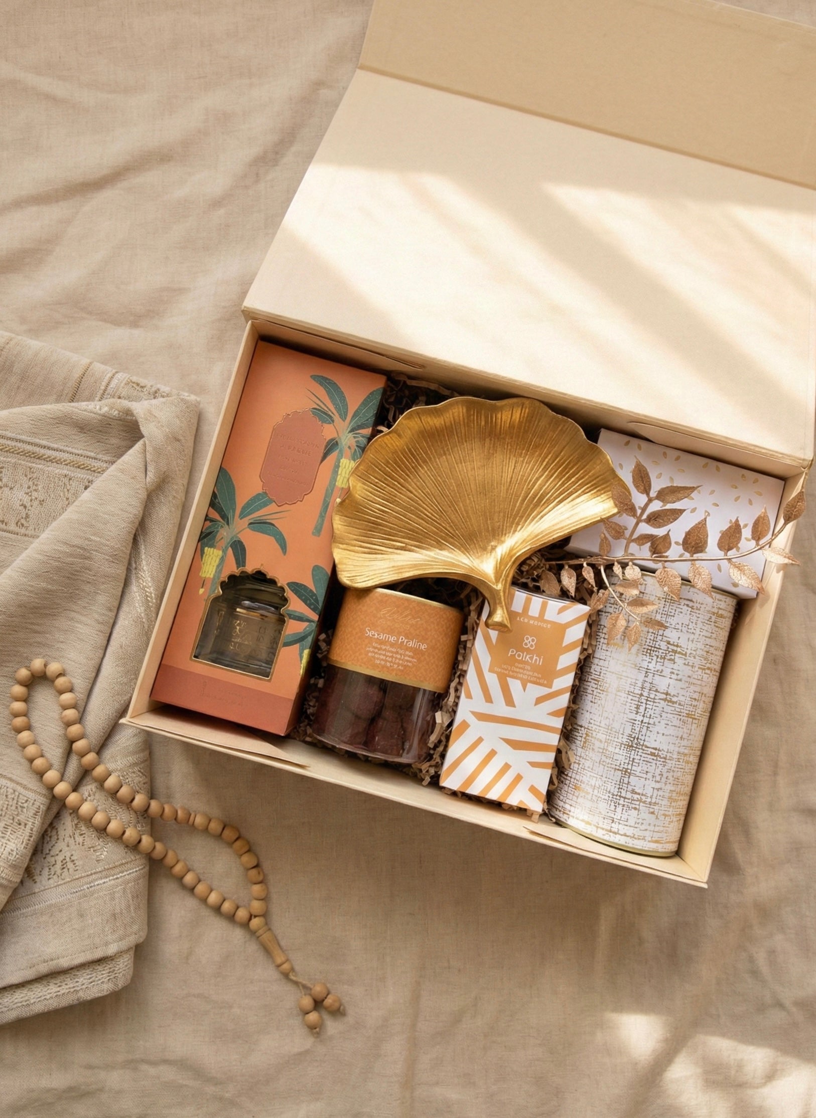 The Sand & Silk Box featuring chocolates, nuts, and a golden tray with unique items in an elegant presentation.