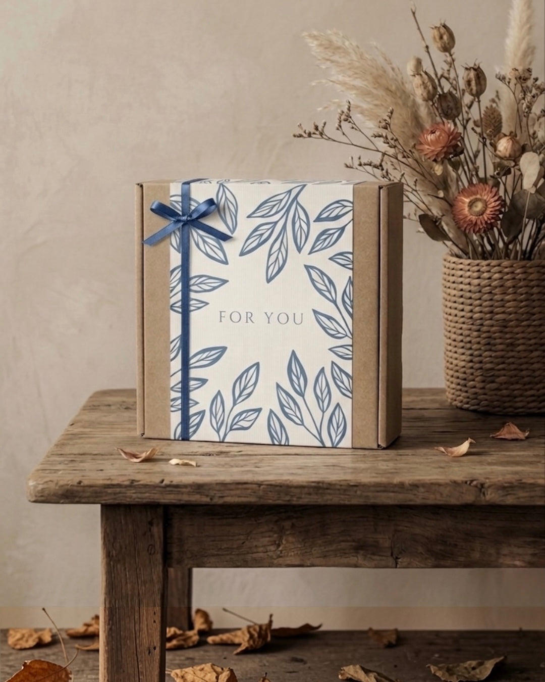 The Slow Morning Box, a mindful tea gift set UAE, beautifully wrapped with a navy leaf design and tied with a ribbon.