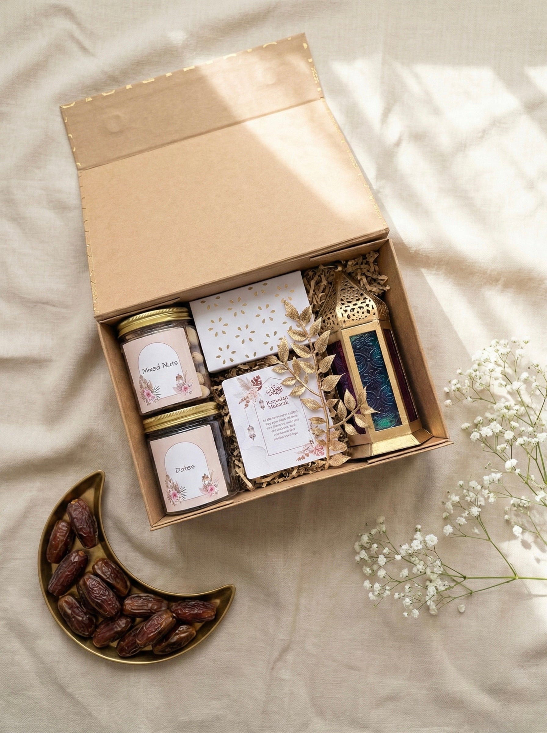 The Sukoon Box featuring jar of dates, mixed nuts, lantern, and card for Eid gift hampers UAE.
